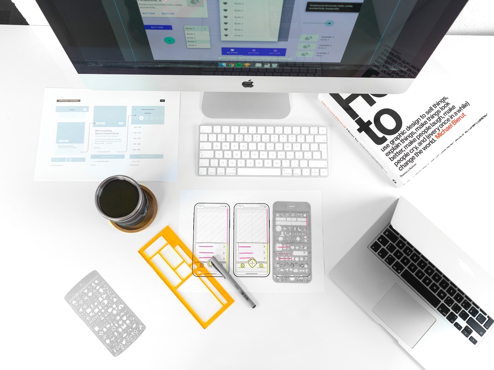 silver MacBook Air on table near iMac